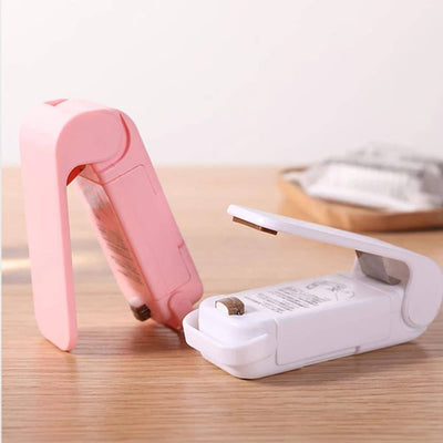 Mini Heat Sealer – Portable Resealer for Food Storage & Snack Bags in pink and white colors, compact design for sealing plastic snack bags.