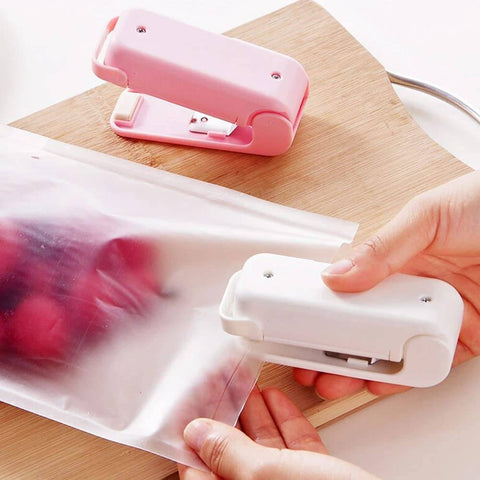 Mini Heat Sealer – Portable Resealer for Food Storage & Snack Bags in pink and white colors, compact design for sealing plastic snack bags.