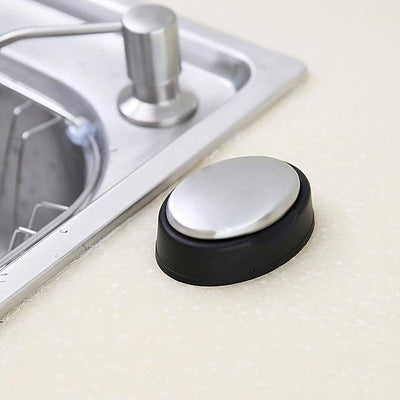 Stainless steel odor remover soap with black base placed near kitchen sink. Ideal for eliminating garlic, onion, and fish smells from hands.