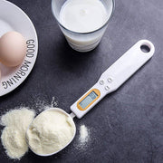 Digital Measuring Spoon Scale with LCD display in black and white, accurately weighing red and green beans for cooking and baking precision.