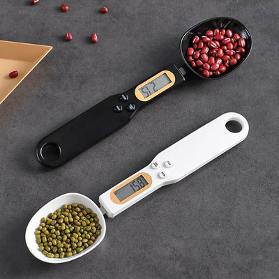 Digital Measuring Spoon Scale with LCD display in black and white, accurately weighing red and green beans for cooking and baking precision.